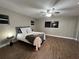 Bedroom features wood-look floors, a ceiling fan, and a neatly made bed at 9681 Sw 97Th Ln, Ocala, FL 34481