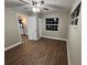 Cozy bedroom with wood-look floors, a ceiling fan, a window, and a closet at 9681 Sw 97Th Ln, Ocala, FL 34481