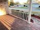 View from the bricked front porch with a white railing, showing the street and adjacent houses at 9681 Sw 97Th Ln, Ocala, FL 34481