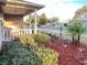 Landscaped front yard featuring lush green bushes and decorative mulch, enhanced by a charming front porch at 9681 Sw 97Th Ln, Ocala, FL 34481