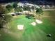 Aerial view of lush golf course with manicured greens, sand traps, and trees at 9681 Sw 97Th Ln, Ocala, FL 34481