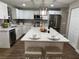 Modern kitchen with white cabinetry, stainless steel appliances, and a large central island at 9681 Sw 97Th Ln, Ocala, FL 34481