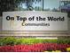 On Top of the World Communities Entrance Sign surrounded by colorful flowers and greenery at 9681 Sw 97Th Ln, Ocala, FL 34481