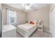 Bedroom with neutral walls, white furniture and ceiling fan at 9839 Sw 99Th Loop, Ocala, FL 34481