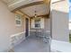 Inviting front porch with stone accents, a hanging light fixture, and a cozy seating area at 9839 Sw 99Th Loop, Ocala, FL 34481