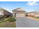 Attached garage with a concrete driveway and manicured landscaping at 9839 Sw 99Th Loop, Ocala, FL 34481