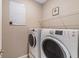 Laundry room featuring a window, shelf and front loading washer and dryer at 9839 Sw 99Th Loop, Ocala, FL 34481