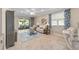 Inviting living room features tile floors, recessed lighting, ceiling fan, and sliding glass doors to screened patio at 9839 Sw 99Th Loop, Ocala, FL 34481