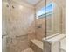 Bright walk-in shower featuring a window and a built-in bench at 9839 Sw 99Th Loop, Ocala, FL 34481