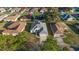 An aerial view of a well-maintained home showcasing its mature landscaping and attached two-car garage at 11569 Sw 71St Cir, Ocala, FL 34476