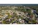 An aerial view of a home in a golf course community surrounded by mature trees and golf fairways at 11569 Sw 71St Cir, Ocala, FL 34476