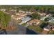 Aerial view of a home in a community with mature trees and landscaping, with a large wooded area in the background at 11569 Sw 71St Cir, Ocala, FL 34476