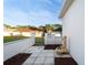 Back patio with stylish fountain feature, offering a private outdoor space and entry gate to the lawn at 11569 Sw 71St Cir, Ocala, FL 34476