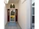 Covered front porch with a glass-paneled door and tiled floor, offering a welcoming entrance to the home at 11569 Sw 71St Cir, Ocala, FL 34476