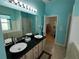 Bathroom with black granite countertops and white porcelain sinks at 11663 Sw 72Nd Cir, Ocala, FL 34476