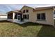 Exterior view of home with screened-in porch, open patio, and lush green lawn at 11663 Sw 72Nd Cir, Ocala, FL 34476