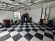 Organized garage showcases a checkered floor, storage solutions, and room for vehicles and hobbies at 11663 Sw 72Nd Cir, Ocala, FL 34476