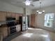 Modern kitchen featuring stainless steel appliances, tan cabinetry, and tiled floors at 11663 Sw 72Nd Cir, Ocala, FL 34476