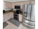 Modern kitchen featuring stainless steel appliances, tan cabinetry, and tiled floors at 11663 Sw 72Nd Cir, Ocala, FL 34476