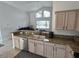 Well-lit kitchen featuring granite countertops and stainless steel dishwasher and sink at 11663 Sw 72Nd Cir, Ocala, FL 34476