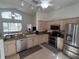 Bright, open kitchen features stainless appliances, granite counters, and breakfast bar at 11663 Sw 72Nd Cir, Ocala, FL 34476