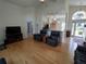 Spacious living room with bamboo floors, comfortable seating, and open to kitchen at 11663 Sw 72Nd Cir, Ocala, FL 34476