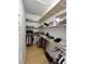 Well-organized walk-in closet with custom shelving for clothes, shoes, and accessories at 11663 Sw 72Nd Cir, Ocala, FL 34476