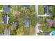 Aerial view of a home with a large front yard shaded by mature trees in a quiet neighborhood at 1225 Se 16Th St, Ocala, FL 34471