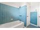 Cozy bathroom with blue tile, a shower-tub combo, and functional fixtures at 1225 Se 16Th St, Ocala, FL 34471