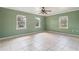 Bright bedroom with pale green walls, tile floors, and multiple windows at 1225 Se 16Th St, Ocala, FL 34471