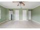 Large bedroom with pale green walls, tile floors, and multiple doors at 1225 Se 16Th St, Ocala, FL 34471