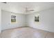 Spacious bedroom with tile floors, neutral paint, and lots of natural light at 1225 Se 16Th St, Ocala, FL 34471