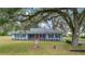 Charming single-story home with manicured lawn, mature trees and inviting front porch at 1225 Se 16Th St, Ocala, FL 34471