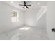 Cozy bedroom with a window, a ceiling fan, and marble floors at 12882 Se 42Nd Ct, Belleview, FL 34420