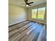 Sunlit bedroom with wood-look floors and a ceiling fan at 13922 Sw 113Th Ln, Dunnellon, FL 34432