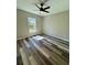 Bright bedroom featuring luxury vinyl plank floor and a ceiling fan at 13922 Sw 113Th Ln, Dunnellon, FL 34432