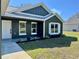 Attractive exterior featuring white trim accenting the home's architecture and verdant front lawn at 13922 Sw 113Th Ln, Dunnellon, FL 34432