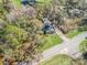 Aerial view of a home surrounded by trees, showcasing its peaceful setting and expansive driveway at 16211 Se 62Nd Pl, Ocklawaha, FL 32179