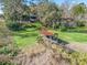 Backyard aerial view featuring a weathered dock structure, lush greenery, and partial view of the charming home at 16211 Se 62Nd Pl, Ocklawaha, FL 32179