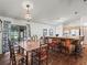 Well-lit dining area with wood floors, seating for eight and access to the kitchen at 16211 Se 62Nd Pl, Ocklawaha, FL 32179