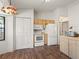 Functional kitchen featuring white appliances and wood-look flooring throughout at 16211 Se 62Nd Pl, Ocklawaha, FL 32179