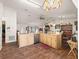 Well-lit kitchen with wood cabinets, stainless steel appliances and wood-look floors at 16211 Se 62Nd Pl, Ocklawaha, FL 32179