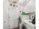 Bright laundry room with washer, dryer, white cabinetry, and access to exterior at 16211 Se 62Nd Pl, Ocklawaha, FL 32179