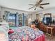 Comfortable main bedroom with a ceiling fan and sliding glass door to the lanai at 16211 Se 62Nd Pl, Ocklawaha, FL 32179