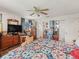 Bedroom featuring a ceiling fan, wood floors and a comfortable aesthetic at 16211 Se 62Nd Pl, Ocklawaha, FL 32179