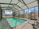 Enclosed swimming pool area for year-round enjoyment, featuring a relaxing atmosphere at 16211 Se 62Nd Pl, Ocklawaha, FL 32179