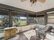 Relaxing enclosed sun room with nature view, offering a peaceful retreat at 16211 Se 62Nd Pl, Ocklawaha, FL 32179