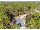 An aerial view of home nestled in a densely wooded area with a long driveway at 18301 Sw 69Th Loop, Dunnellon, FL 34432