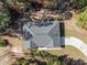 A bird's-eye view of the house, highlighting its unique roof design and surrounding landscape at 18301 Sw 69Th Loop, Dunnellon, FL 34432