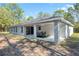 Exterior view of the home featuring a spacious covered patio and backyard at 18301 Sw 69Th Loop, Dunnellon, FL 34432